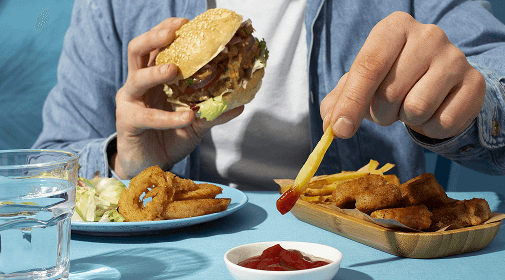 Close-up of person eating fast food