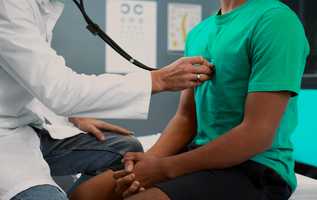 asian man having a check-up w/ a doctor; hospital/clinic setting