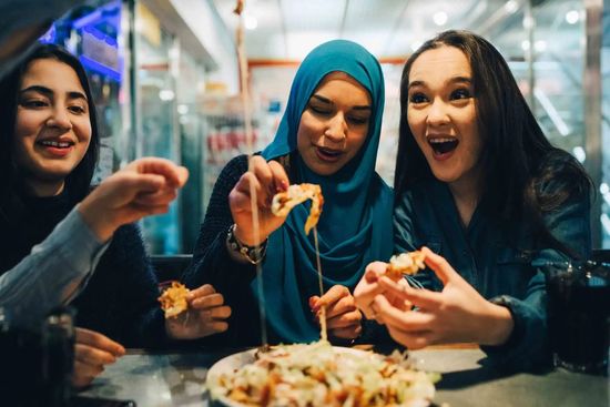 Three Women Happily Eating