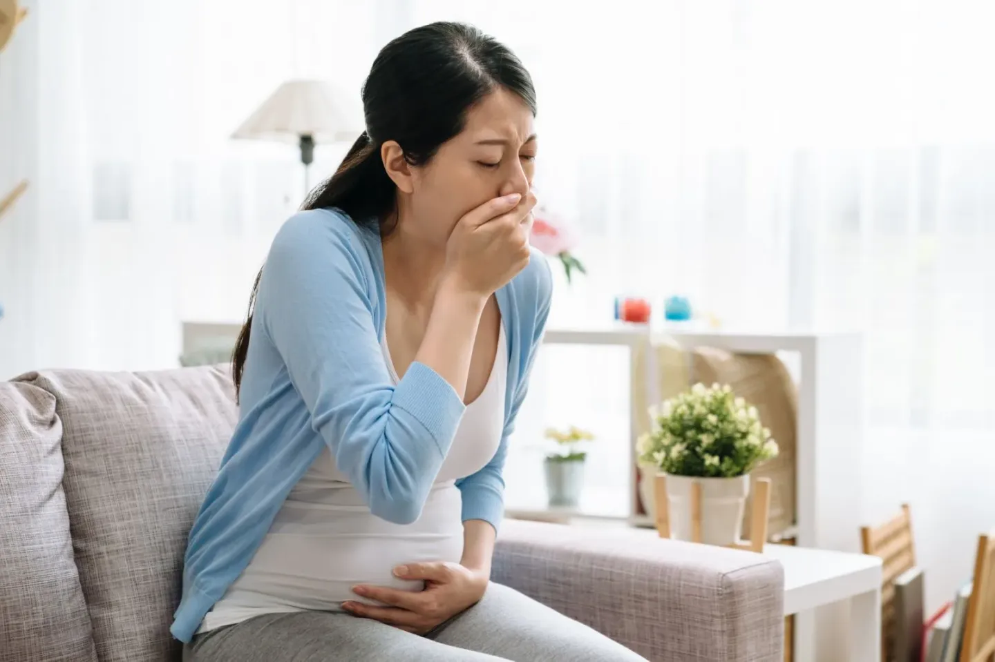 Woman appearing to throw up due to Heartburn