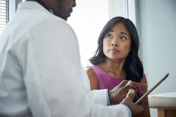 Woman consulting doctor
