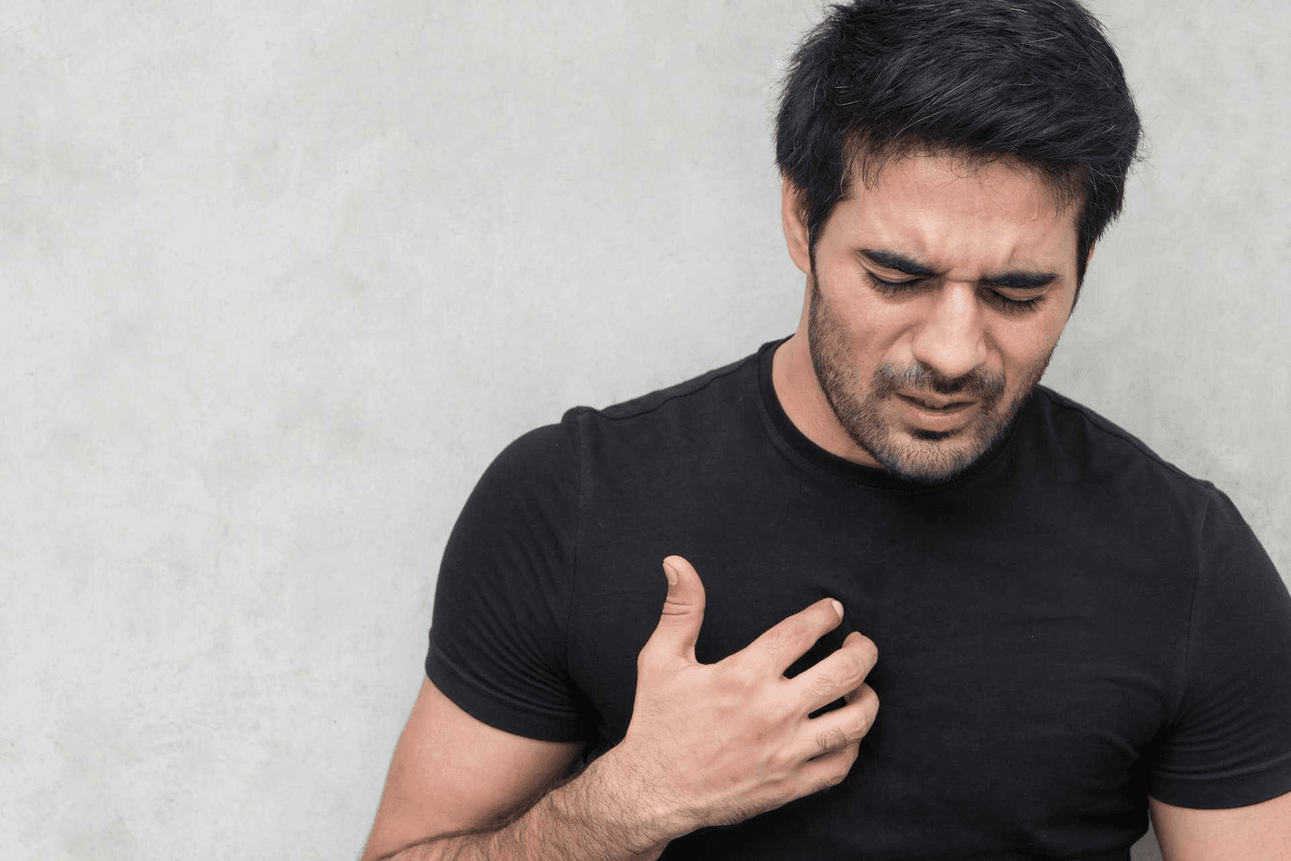 Man with heartburn palm on chest